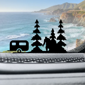 Camp Trailer, RV, with Sasquatch, Big Foot & Trees Easter Egg Windshield Decal Sticker on car window in black.