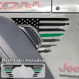 Black tattered, torn and weathered American flag with a green middle line decal sticker, filling in the side fender vent area on a jeep wrangler.