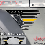 Black tattered, torn and weathered American flag with a yellow middle line decal sticker, filling in the side fender vent area on a jeep wrangler.